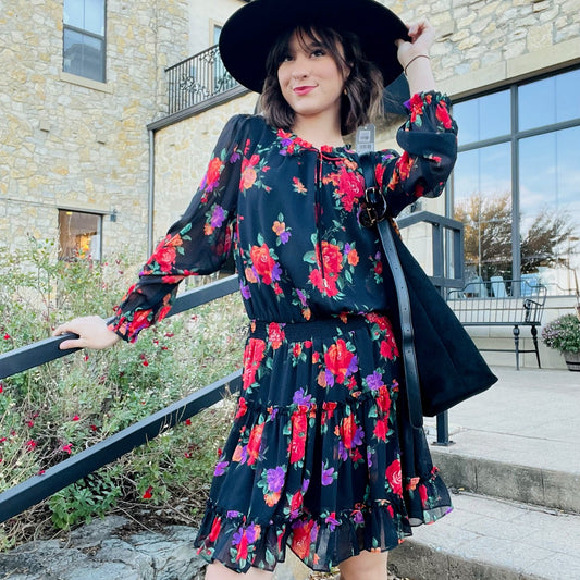 floral print dress, black floral dress, ruffle tiered dress, long sleeve floral mini dress, semi sheer sleeves dress, v notch neckline dress, tie neck dress, fall wedding guest outfit, shower and party dress, boutique floral outfit, feminine floral style, romantic ruffle dress, layered tiered mini dress, floral chiffon dress, lined lightweight dress, multicolor floral pattern, floral dress for events, dinner date outfit, cute boutique dress, black background floral print, boho chic floral dress, fall event 