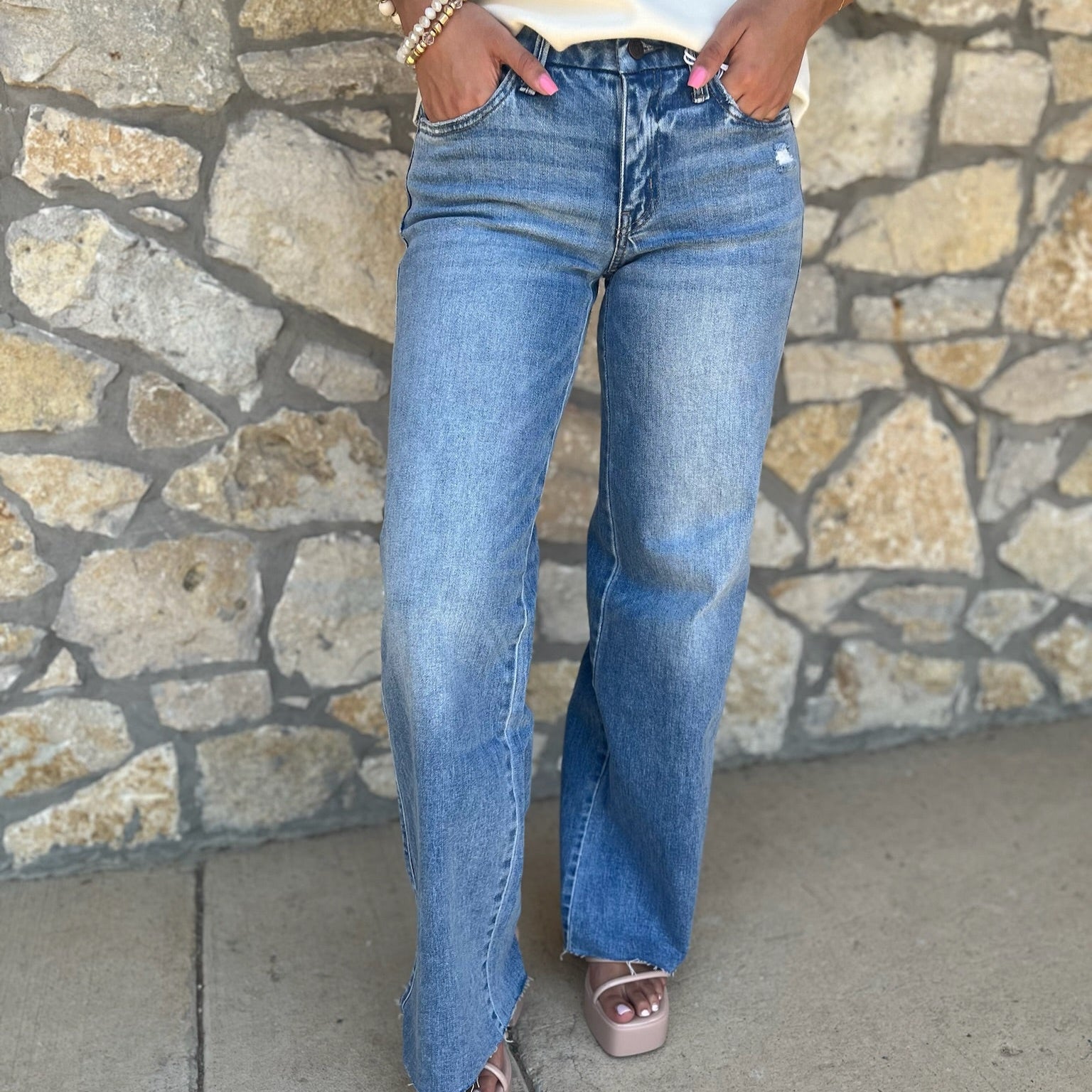 mid rise wide leg jeans, comfort stretch denim, raw hem jeans, slightly distressed jeans, full length denim, clean cut jeans, everyday wide leg jeans, modern denim style, casual chic jeans, versatile denim pants, polished wide leg denim, relaxed fit jeans, trendy wide leg silhouette, comfortable mid rise jeans, classic blue jeans, effortless everyday denim, stylish raw edge jeans, laid back denim look, timeless wide leg jeans, soft stretch denim