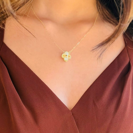 gold clover necklace, designer inspired jewelry, textured clover pendant, dainty gold necklace, 14k gold plated necklace, everyday layering necklace, minimalist gold jewelry, chic statement necklace, lucky clover charm, timeless gold accessory, lightweight dainty necklace, adjustable chain necklace, classic gold pendant, elegant layering piece, solid gold hardware, stylish clover necklace, trendy gold jewelry, feminine gold necklace, versatile necklace for stacking, delicate gold chain