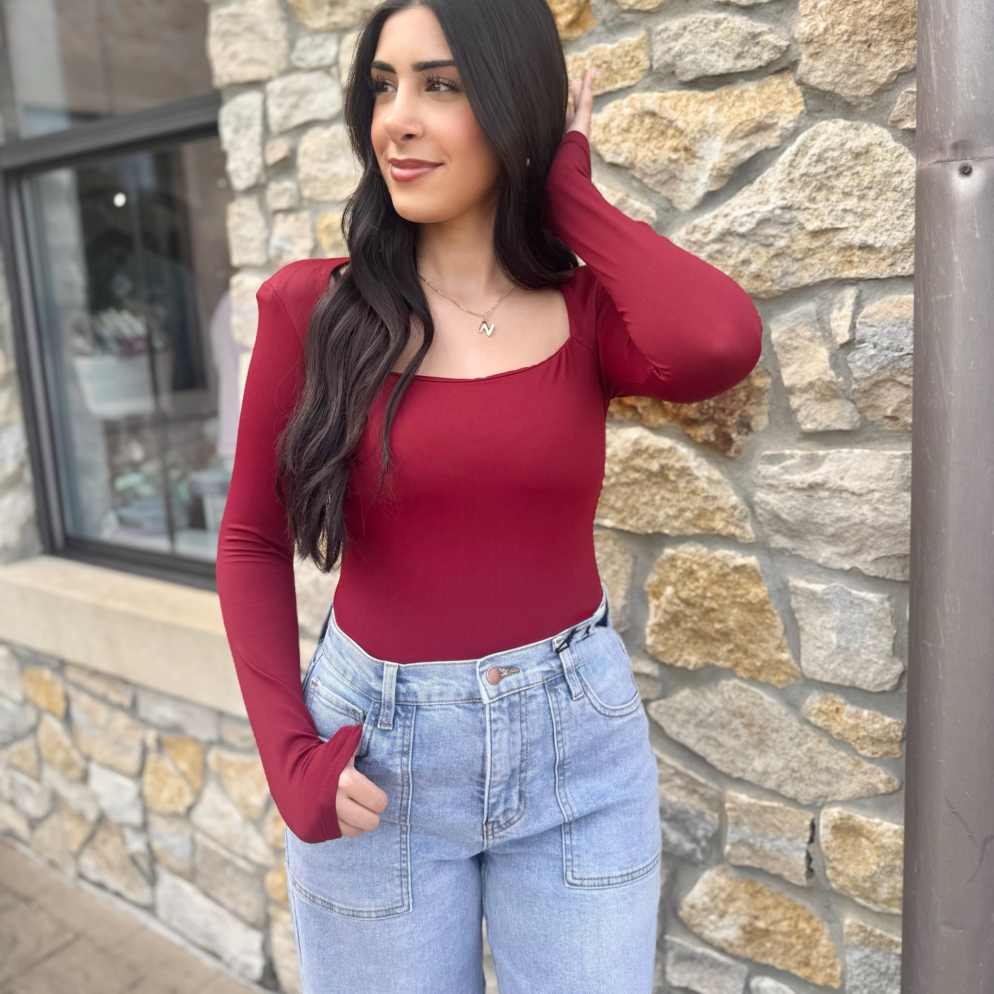 long sleeve bodysuit, square neck bodysuit, fitted bodysuit, stretchy bodysuit, nylon elastane bodysuit, versatile wardrobe essential, chic layering piece, flattering bodysuit for women, everyday basics, sleek square neckline, snap closure bodysuit, form-fitting top, dress up or down, minimalist style bodysuit, trendy neutral bodysuit