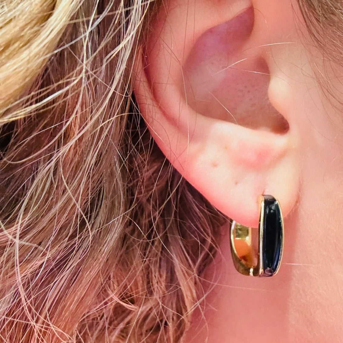 glossy black enamel earrings, black and gold hoop earrings, minimalist hoop earrings, modern black enamel jewelry, small everyday hoops, polished gold hoop earrings, sleek contrast earrings, lightweight hoop earrings, refined statement hoops, versatile everyday jewelry, black accent hoop earrings, gold metal hoop accessories, trendy small hoops for women, compact hoop earrings, enamel inlay earrings