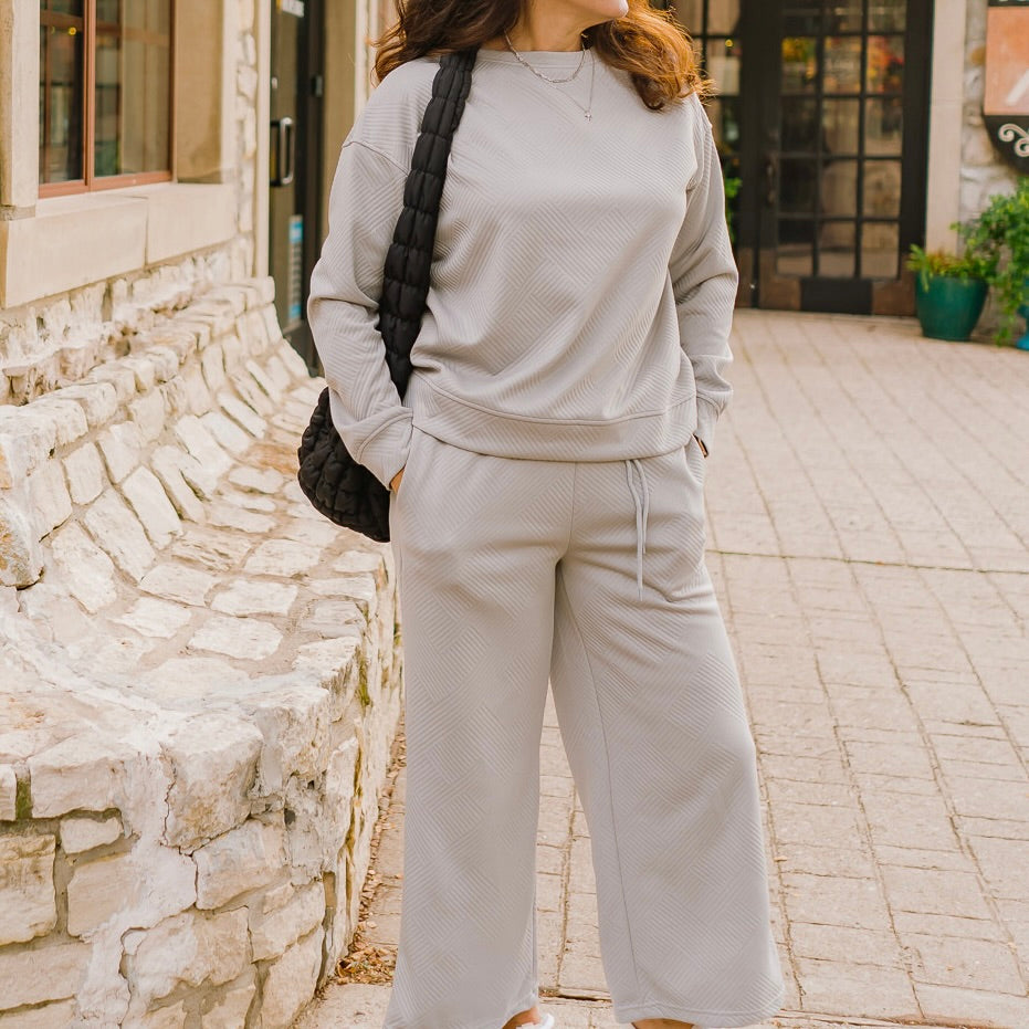 textured pullover jogger set, cozy two-piece set, quilted loungewear set, wide leg jogger set, polyester elastane set, casual chic loungewear, matching pullover and jogger, comfy home outfit, trendy loungewear, boutique lounge set, warm loungewear outfit, relaxed fit pullover set, everyday cozy set, stylish homewear, soft quilted loungewear, versatile pullover jogger, effortless chic loungewear, all-day comfort outfit, casual athleisure set, fashion-forward lounge set