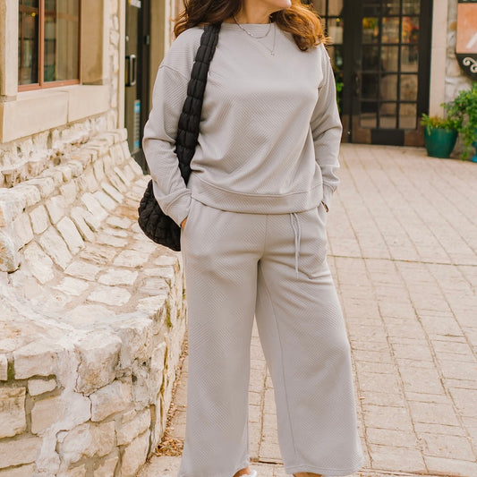textured pullover jogger set, cozy two-piece set, quilted loungewear set, wide leg jogger set, polyester elastane set, casual chic loungewear, matching pullover and jogger, comfy home outfit, trendy loungewear, boutique lounge set, warm loungewear outfit, relaxed fit pullover set, everyday cozy set, stylish homewear, soft quilted loungewear, versatile pullover jogger, effortless chic loungewear, all-day comfort outfit, casual athleisure set, fashion-forward lounge set