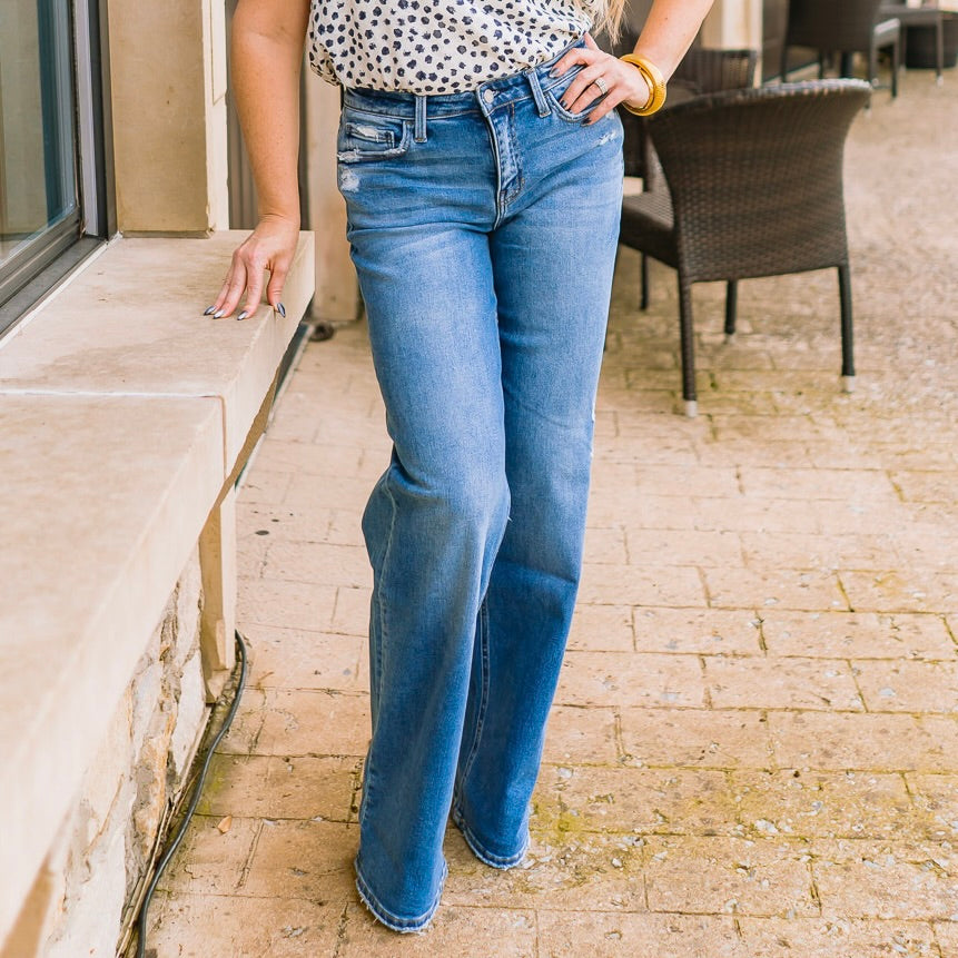 mid rise jeans, wide leg jeans, full length denim, comfort stretch jeans, relaxed fit jeans, slightly distressed denim, women’s wide leg pants, boutique denim, flattering mid rise jeans, long inseam jeans, 34 inch inseam jeans, versatile blue jeans, casual chic denim, everyday wide leg jeans, trendy fall denim, effortless jeans for women, polished wide leg silhouette, elevated basics denim, Sweet Voyage jeans, T6613 jeans, comfortable women’s jeans, classic blue denim, modern wide leg trousers