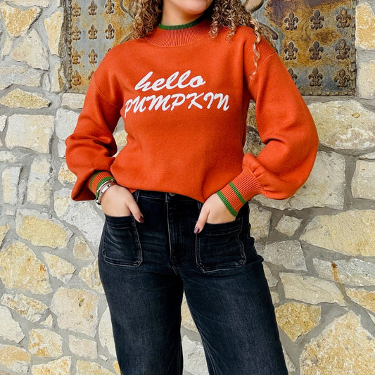 hello pumpkin sweater, fall graphic sweater, pumpkin orange sweater, cozy fall pullover, balloon sleeve sweater, relaxed fit sweater, autumn graphic sweatshirt, festive fall top, crew neck sweater, green trim sweater, cute fall outfit, cozy pumpkin sweater, seasonal knit top, playful fall fashion, thanksgiving sweater, casual autumn outfit, bold lettering sweater, comfy fall essential, statement fall sweater, trendy graphic knit