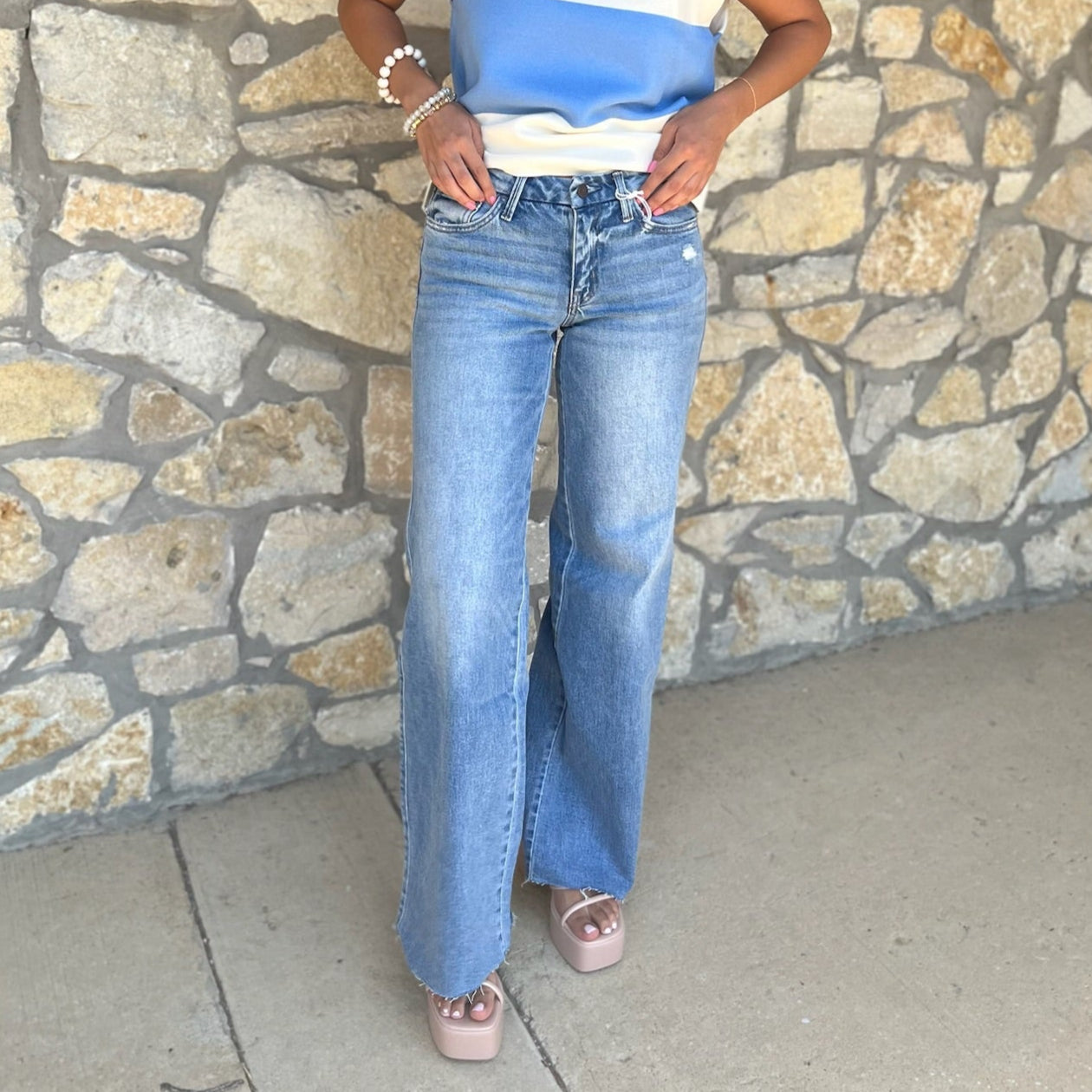 mid rise wide leg jeans, comfort stretch denim, raw hem jeans, slightly distressed jeans, full length denim, clean cut jeans, everyday wide leg jeans, modern denim style, casual chic jeans, versatile denim pants, polished wide leg denim, relaxed fit jeans, trendy wide leg silhouette, comfortable mid rise jeans, classic blue jeans, effortless everyday denim, stylish raw edge jeans, laid back denim look, timeless wide leg jeans, soft stretch denim