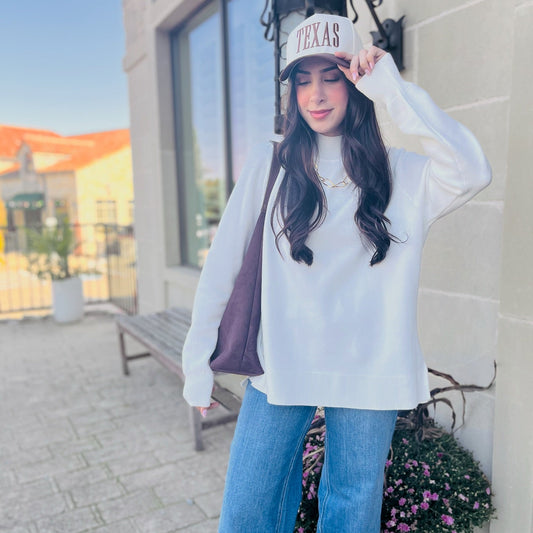 ivory mock neck sweater, cream knit sweater, boutique fall sweater, cozy neutral sweater, side slit pullover, classic ivory sweater, chic winter sweater, timeless cream sweater, soft viscose knit, mock neck cream pullover, neutral capsule wardrobe piece, elevated basics for women, trendy boutique sweater, layering sweater for fall, ivory ribbed knit top, versatile winter outfit, neutral sweater outfit, cozy cream sweater women, dressy casual sweater, knitwear for layering, minimalist winter fashion, boutiqu