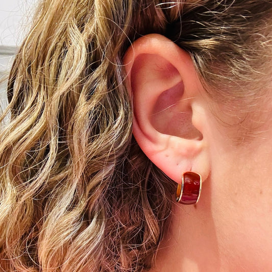 glossy burgundy enamel earrings, burgundy and gold hoop earrings, chunky hoop earrings, modern statement hoops, bold enamel jewelry, small chunky hoops, polished gold edge earrings, lightweight hoop earrings, rich tone enamel earrings, everyday statement earrings, versatile gold hoop accessories, trendy chunky hoops for women, curved hoop silhouette earrings, warm tone enamel hoops, gold metal hoop jewelry