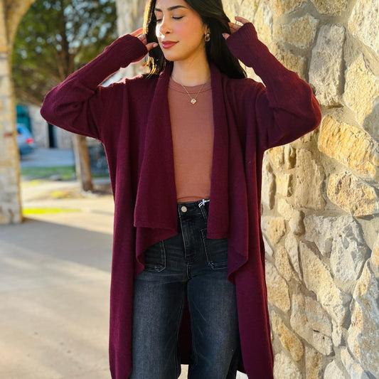 wine lapel cardigan, wine cardigan coat, fall layering jacket, longline cardigan, open front coat, boutique cardigan coat, lightweight fall jacket, structured cardigan, wine outerwear, lapel jacket women, soft layering piece, burgundy cardigan, cozy chic coat, fall fashion staple, dressy cardigan for work, casual layering coat, versatile fall jacket, women’s outerwear boutique, deep red cardigan coat, open front fall coat, trendy fall outfit, long wine coat, transitional fall piece, sophisticated cardigan