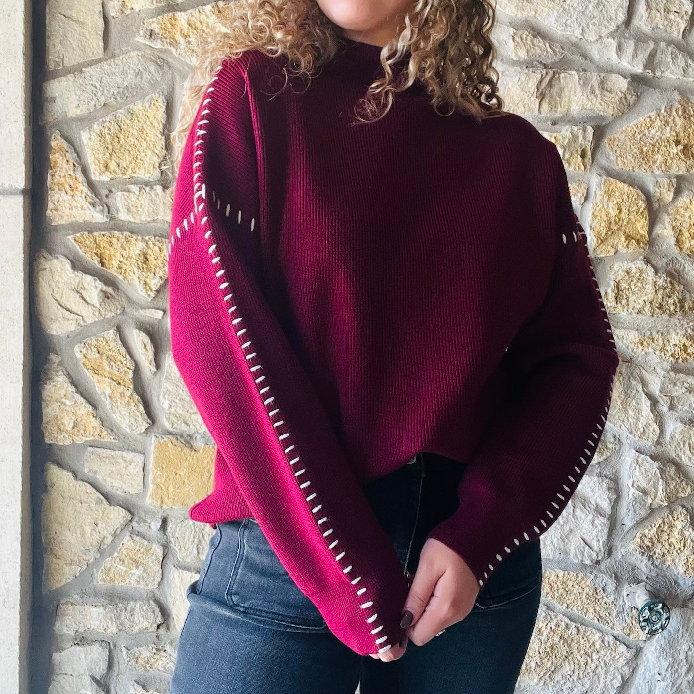 oversized maroon sweater, contrast blanket stitch, relaxed proportions, standout stitching details, ultra-soft knit, mock neck sweater, ribbed detailing, solid maroon sweater, white stitching accents, cozy oversized sweater, chic fall sweater, bestselling brand sweater, elevated cold weather staple, casual weekend style, feminine layered look, versatile fall and winter sweater, viscose polyester nylon blend