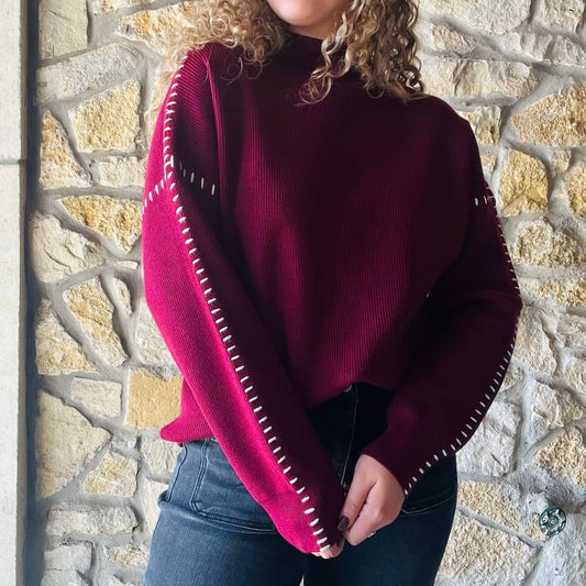 oversized maroon sweater, contrast blanket stitch, relaxed proportions, standout stitching details, ultra-soft knit, mock neck sweater, ribbed detailing, solid maroon sweater, white stitching accents, cozy oversized sweater, chic fall sweater, bestselling brand sweater, elevated cold weather staple, casual weekend style, feminine layered look, versatile fall and winter sweater, viscose polyester nylon blend