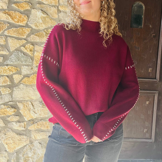 oversized maroon sweater, contrast blanket stitch, relaxed proportions, standout stitching details, ultra-soft knit, mock neck sweater, ribbed detailing, solid maroon sweater, white stitching accents, cozy oversized sweater, chic fall sweater, bestselling brand sweater, elevated cold weather staple, casual weekend style, feminine layered look, versatile fall and winter sweater, viscose polyester nylon blend