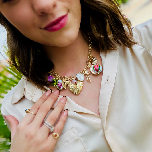 charm necklace, gold charm necklace, statement necklace, vintage-inspired jewelry, eclectic charm jewelry, pastel charm necklace, floral charm necklace, heart locket necklace, bow charm necklace, seashell charm necklace, trendy gold necklace, boho chic jewelry, boutique statement necklace, layered gold chain, adjustable chain necklace, feminine jewelry, gift for her, trendy boutique accessories, vintage charm necklace, handmade charm jewelry, whimsical necklace, everyday statement jewelry, romantic jewelry 