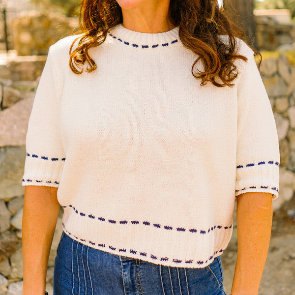 stitch detail top, knit short sleeve top, white and navy top, textured knit blouse, crew neck knit top, classic short sleeve sweater, casual chic top, office knit top, brunch outfit top, everyday knit blouse, lightweight sweater top, navy trim top, polished casual top, versatile white top, feminine knit shirt, stylish textured top, soft acrylic knit top, minimal knit blouse, timeless short sleeve top, effortless everyday top