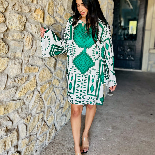 green geometric print dress, fall mini dress, long sleeve mini dress, bell sleeve dress, tassel tie dress, printed geo dress, round neck dress, fall fashion dress, woven mini dress, boho chic dress, boutique fall outfit, trendy green dress, modern print mini, lightweight fall dress, autumn outfit inspo, flowy mini dress, polyester lined dress, stylish day dress, weekend brunch dress