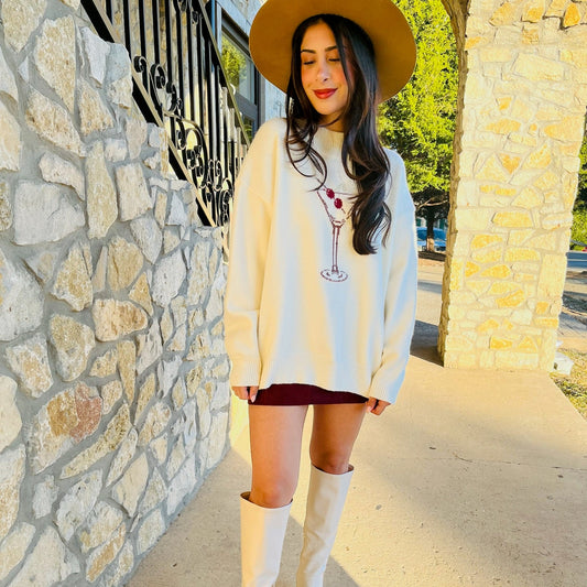 cream sweater, burgundy martini glass sweater, mock neck sweater, long sleeve knit top, cozy chic sweater, flirty sweater, preppy style sweater, cocktail hour sweater, fun statement sweater, layering sweater, fall wardrobe sweater, women's knit top, casual chic sweater, playful design sweater, versatile sweater, night out outfit sweater, holiday party sweater, cozy layering knit, acrylic blend sweater, sophisticated knit top
