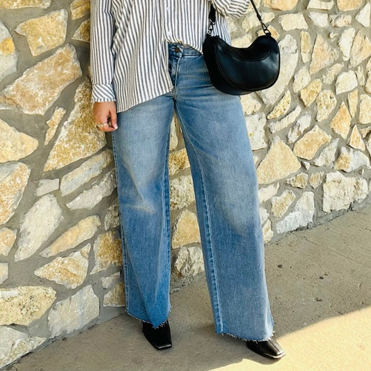 mid rise wide leg jeans, comfort stretch denim, raw hem jeans, slightly distressed jeans, full length denim, clean cut jeans, everyday wide leg jeans, modern denim style, casual chic jeans, versatile denim pants, polished wide leg denim, relaxed fit jeans, trendy wide leg silhouette, comfortable mid rise jeans, classic blue jeans, effortless everyday denim, stylish raw edge jeans, laid back denim look, timeless wide leg jeans, soft stretch denim