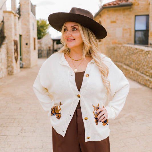 horse cardigan, western-inspired cardigan, graphic knit cardigan, ivory button-down cardigan, cozy fall cardigan, horse print sweater, boutique western fashion, long sleeve knit cardigan, casual chic cardigan, soft knit sweater, fall statement sweater, horse lover gift, rustic chic cardigan, western style sweater, ivory knit cardigan, layering cardigan, trendy fall sweater, women’s western cardigan, boutique fall fashion, unique horse print top, casual fall outfit, chic graphic sweater, autumn wardrobe stap