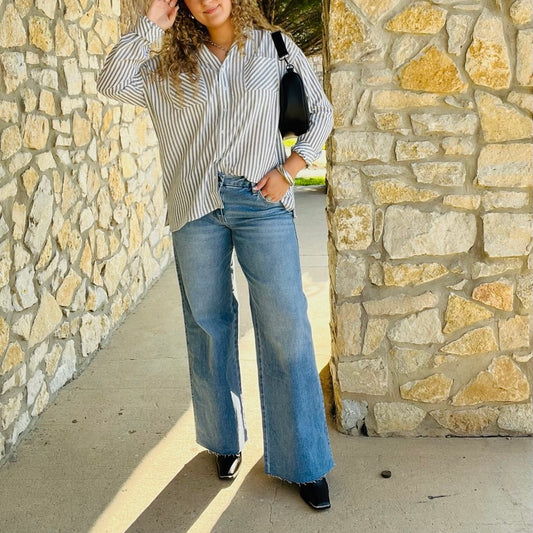 mid rise wide leg jeans, comfort stretch denim, raw hem jeans, slightly distressed jeans, full length denim, clean cut jeans, everyday wide leg jeans, modern denim style, casual chic jeans, versatile denim pants, polished wide leg denim, relaxed fit jeans, trendy wide leg silhouette, comfortable mid rise jeans, classic blue jeans, effortless everyday denim, stylish raw edge jeans, laid back denim look, timeless wide leg jeans, soft stretch denim