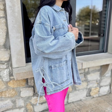 tied up denim jacket, oversized denim jacket, boyfriend fit denim jacket, side tie detail jacket, statement denim jacket, trendy jean jacket, casual oversized jacket, women’s denim outerwear, fall layering piece, front pocket jean jacket, unique denim style, elevated casual outfit, street style denim jacket