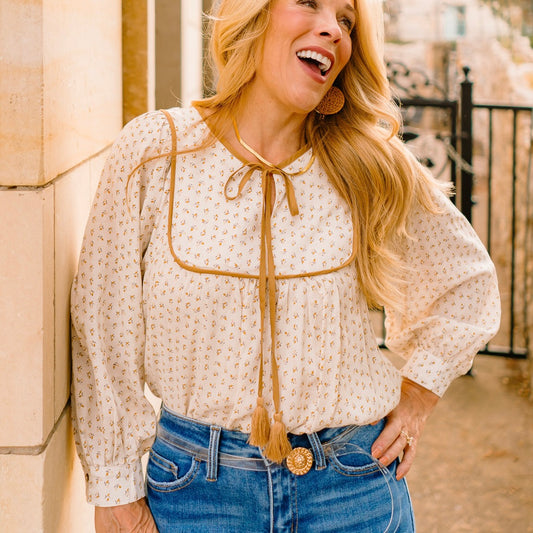 ditsy print blouse, boho floral blouse, linen long sleeve top, tassel tie blouse, feminine boho blouse, boutique fall top, gold trim blouse, lightweight printed blouse, bohemian chic shirt, casual floral top, girly fall outfit, boutique blouse for women, floral peasant top, boho fall fashion, soft linen blouse, fall wardrobe staple, relaxed fit blouse, romantic boho style, everyday floral blouse, country chic outfit, trendy boutique top, versatile fall blouse, tassel neckline blouse, boho-inspired