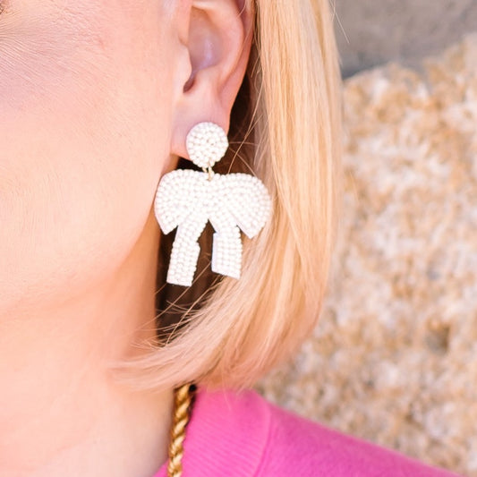 beaded bow earrings, beaded earrings, earrings, oversized earrings, bead earrings, bow earrings, white bow earrings, white bead earrings, statement earrings, statement accessories, summer earrings, summer accessories, spring earrings, spring accessories 