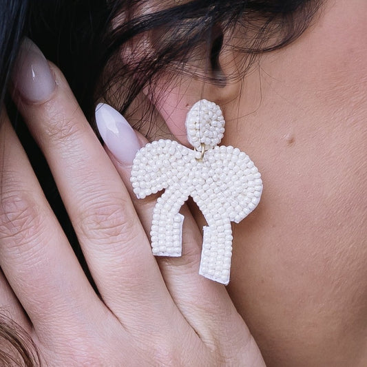 beaded bow earrings, beaded earrings, earrings, oversized earrings, bead earrings, bow earrings, white bow earrings, white bead earrings, statement earrings, statement accessories, summer earrings, summer accessories, spring earrings, spring accessories