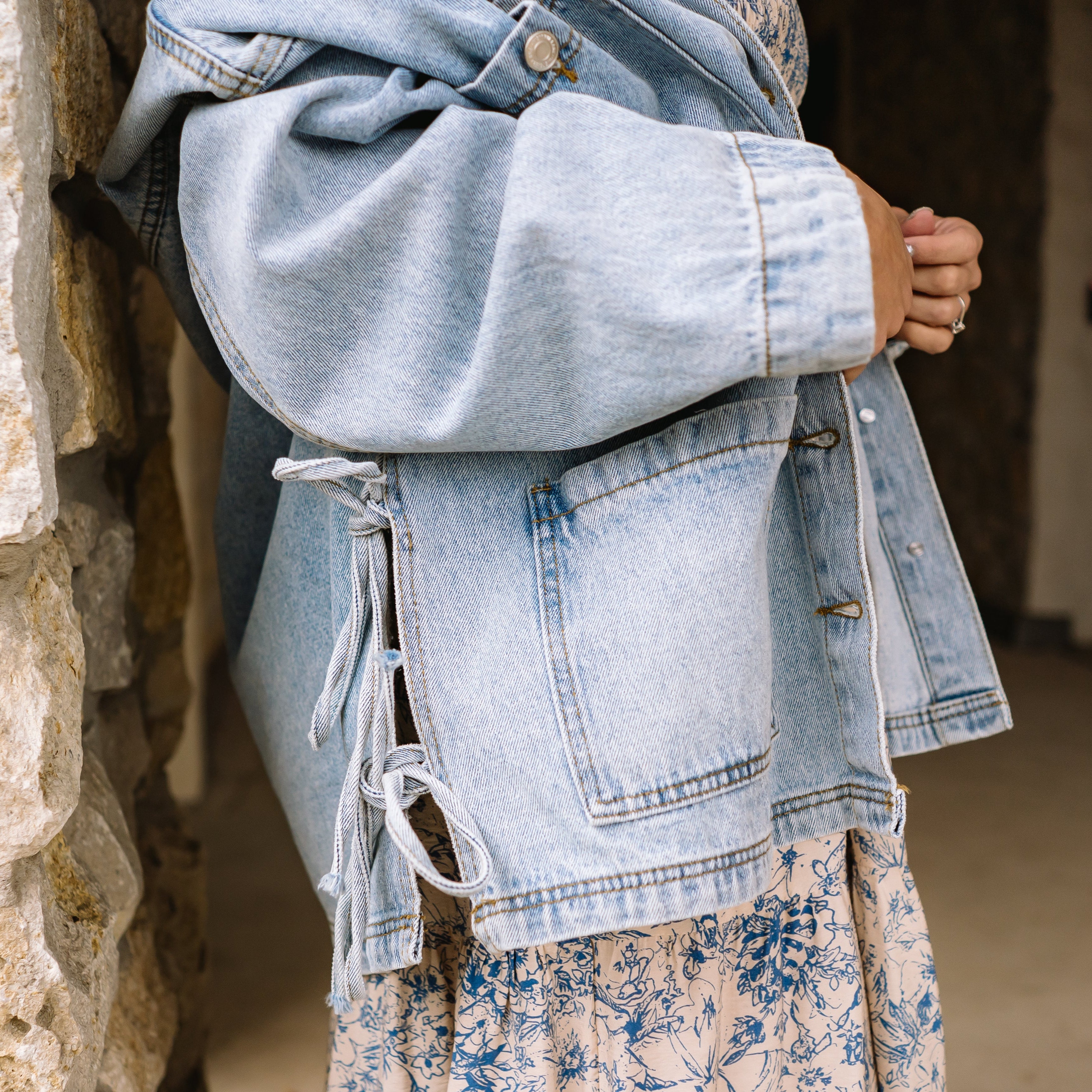 tied up denim jacket, oversized denim jacket, boyfriend fit denim jacket, side tie detail jacket, statement denim jacket, trendy jean jacket, casual oversized jacket, women’s denim outerwear, fall layering piece, front pocket jean jacket, unique denim style, elevated casual outfit, street style denim jacket