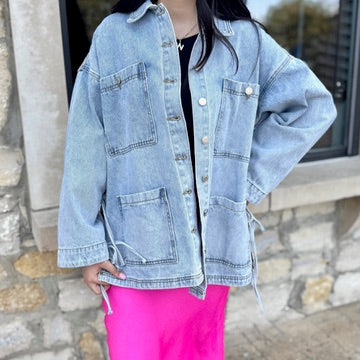 tied up denim jacket, oversized denim jacket, boyfriend fit denim jacket, side tie detail jacket, statement denim jacket, trendy jean jacket, casual oversized jacket, women’s denim outerwear, fall layering piece, front pocket jean jacket, unique denim style, elevated casual outfit, street style denim jacket