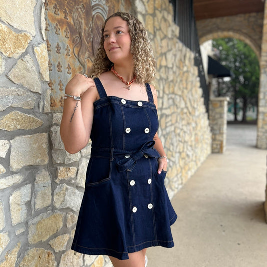 denim mini dress, dark wash denim dress, button front denim dress, a-line jean dress, belted denim dress, denim sash tie dress, adjustable strap dress, square neckline dress, casual denim outfit, flirty jean dress, boutique denim dress, modern western style, fall denim trends, classic blue jean dress, women’s denim fashion, dress with belt loops, everyday denim dress, chic denim mini, versatile denim dress, cute denim day dress, trendy denim outfit, stylish boutique dress, elevated casual denim