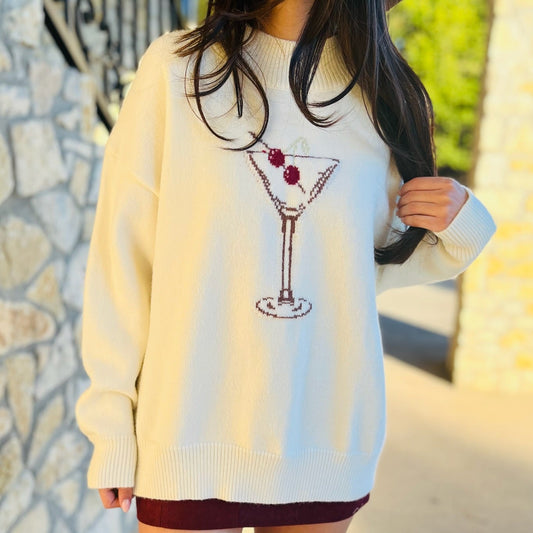 cream sweater, burgundy martini glass sweater, mock neck sweater, long sleeve knit top, cozy chic sweater, flirty sweater, preppy style sweater, cocktail hour sweater, fun statement sweater, layering sweater, fall wardrobe sweater, women's knit top, casual chic sweater, playful design sweater, versatile sweater, night out outfit sweater, holiday party sweater, cozy layering knit, acrylic blend sweater, sophisticated knit top
