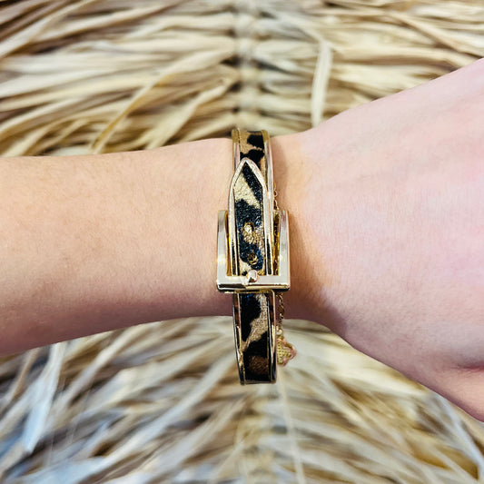 leopard bracelet, animal print bracelet, belt style bracelet, gold hardware bracelet, statement jewelry, adjustable bracelet, trendy accessories, boutique jewelry, fashion bracelet, leopard print jewelry, chic bracelet, edgy bracelet, women’s bracelet, stylish bracelet, bold accessories