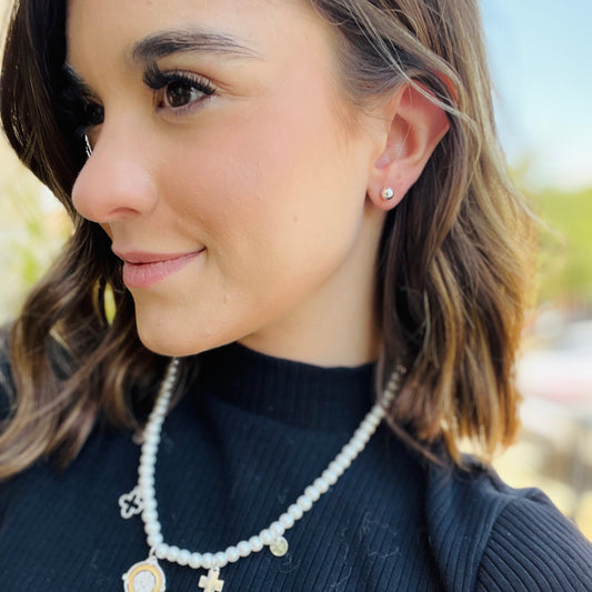 pearl charm necklace, dainty pearl jewelry, charm pendant necklace, mixed metal necklace, gold and silver necklace, pearl chain necklace, elegant layered necklace, timeless pearl necklace, chic everyday jewelry, necklace and earring set, simple stud earrings, giftable jewelry set, feminine charm necklace, classy gold silver jewelry, delicate pearl chain, versatile layering necklace, non hypoallergenic necklace, pearl jewelry gift idea, statement charm necklace, elevated everyday style