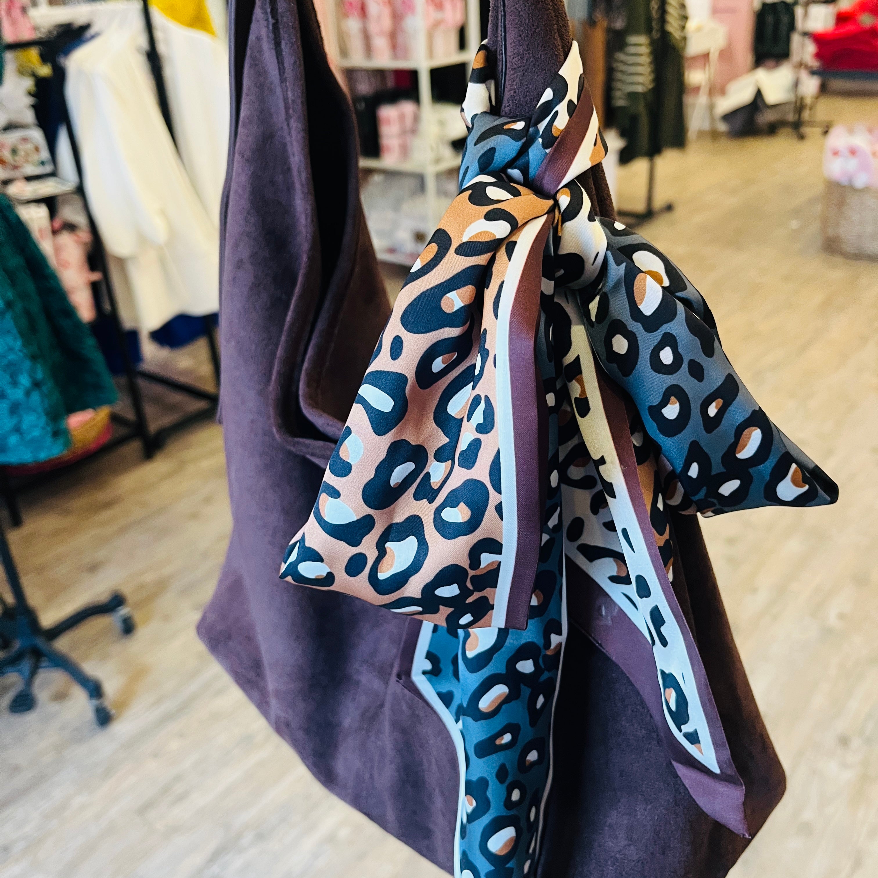 long tapered scarf, silky long scarf, slim ribbon scarf, versatile hair scarf, neck scarf accessory, bag tie scarf, dual pattern scarf, multicolor leopard scarf, black floral scarf, lightweight silky scarf, 50 inch long scarf, patterned ribbon scarf, fashion accessory scarf, colorful slim scarf, trendy twilly style scarf, elongated scarf for women, chic styling scarf, statement print scarf